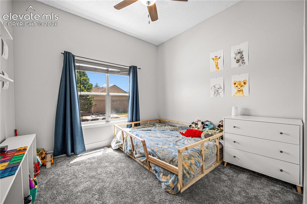 Image 27 of 50: Vaulted ceiling with a ceiling fan and two rectangular skylights