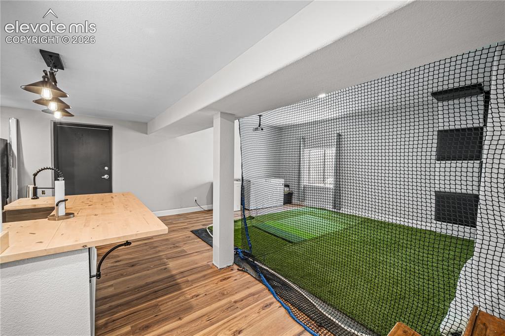 Image 34 of 50: Recreational space featuring wall-mounted television, built-in shelving, re
