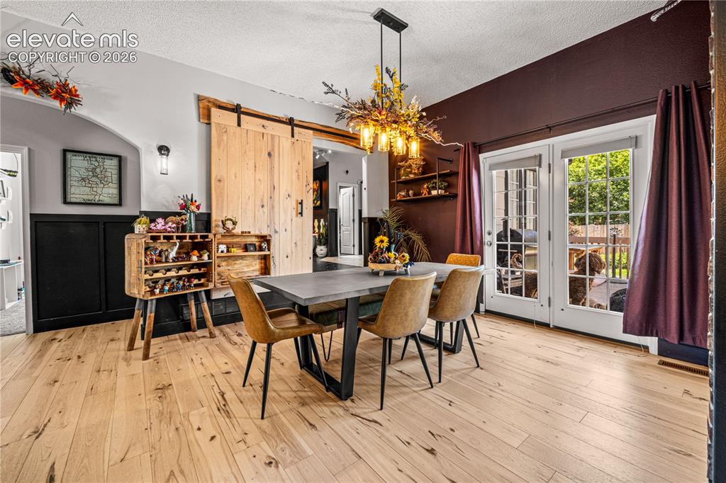 Image 6 of 50: Light wood-finish flooring throughout, complemented by a large window with