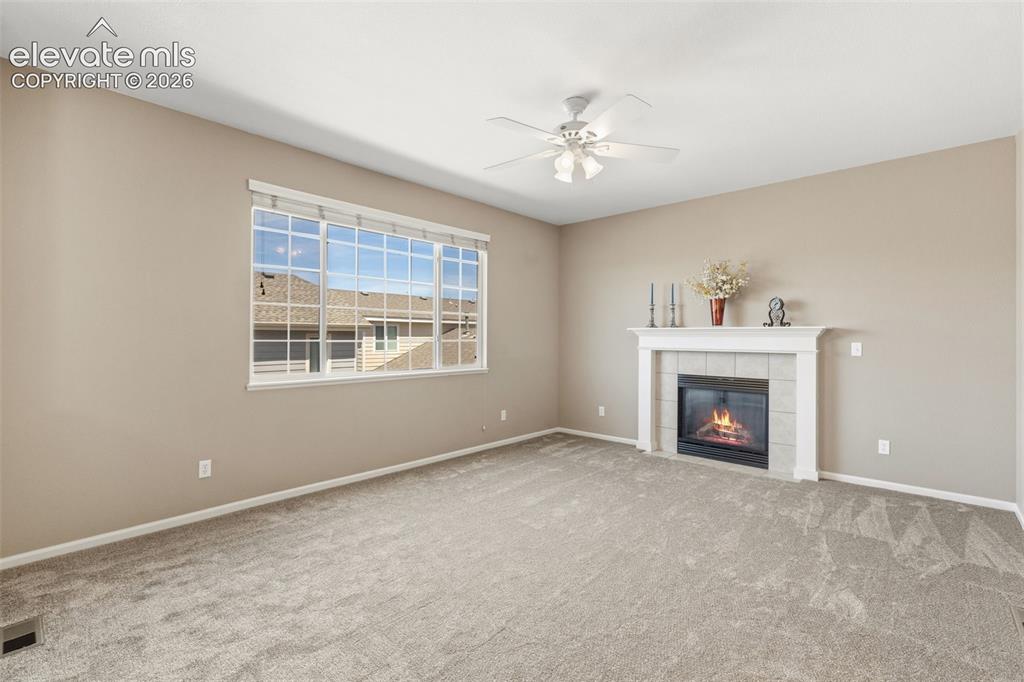 Image 15 of 40: Cozy fireplace in family room