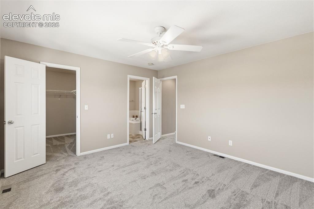 Image 21 of 40: Walk in closet in primary bedroom