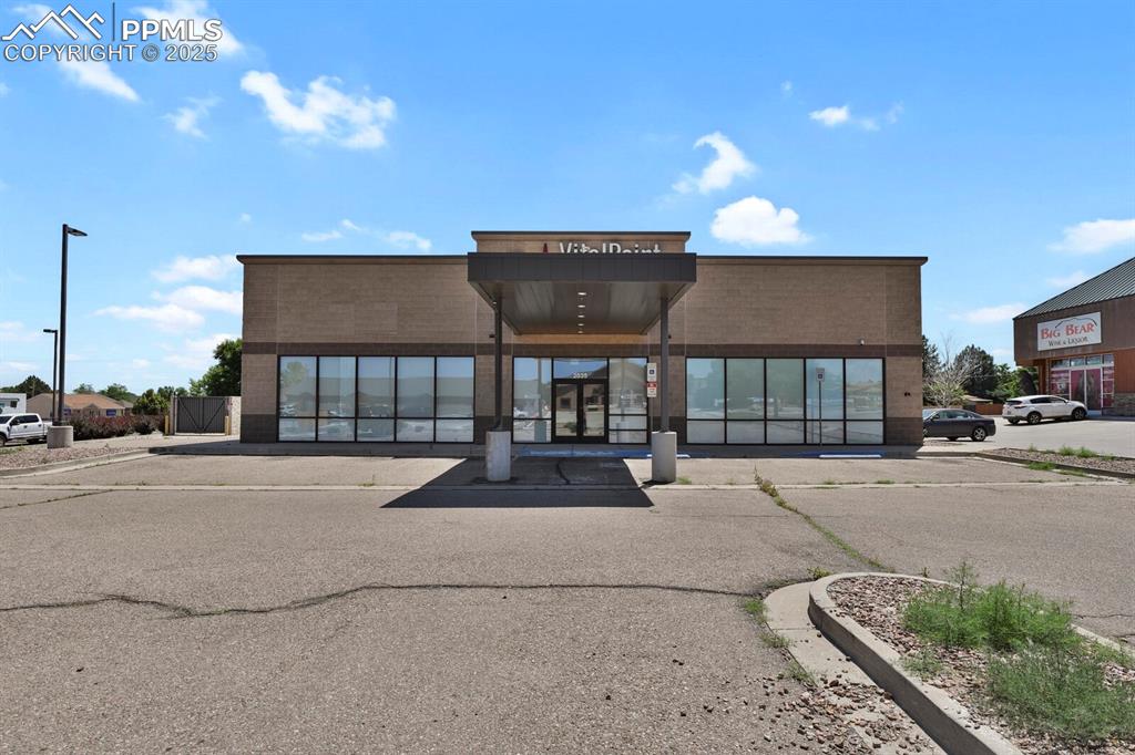 Caption: View of commercial property with uncovered parking