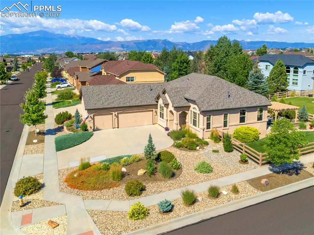 Image 2 of 50: South-facing driveway with a side-entry, insulated garage and a 2022 Class 