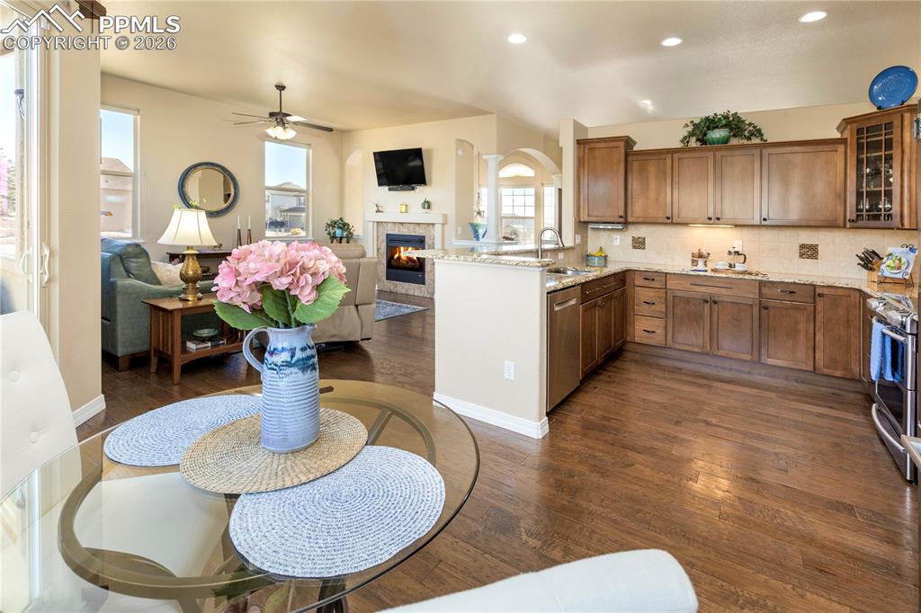Image 22 of 50: Beautiful kitchen with breakfast bar, maple cabinets, 5" plank hickory wood