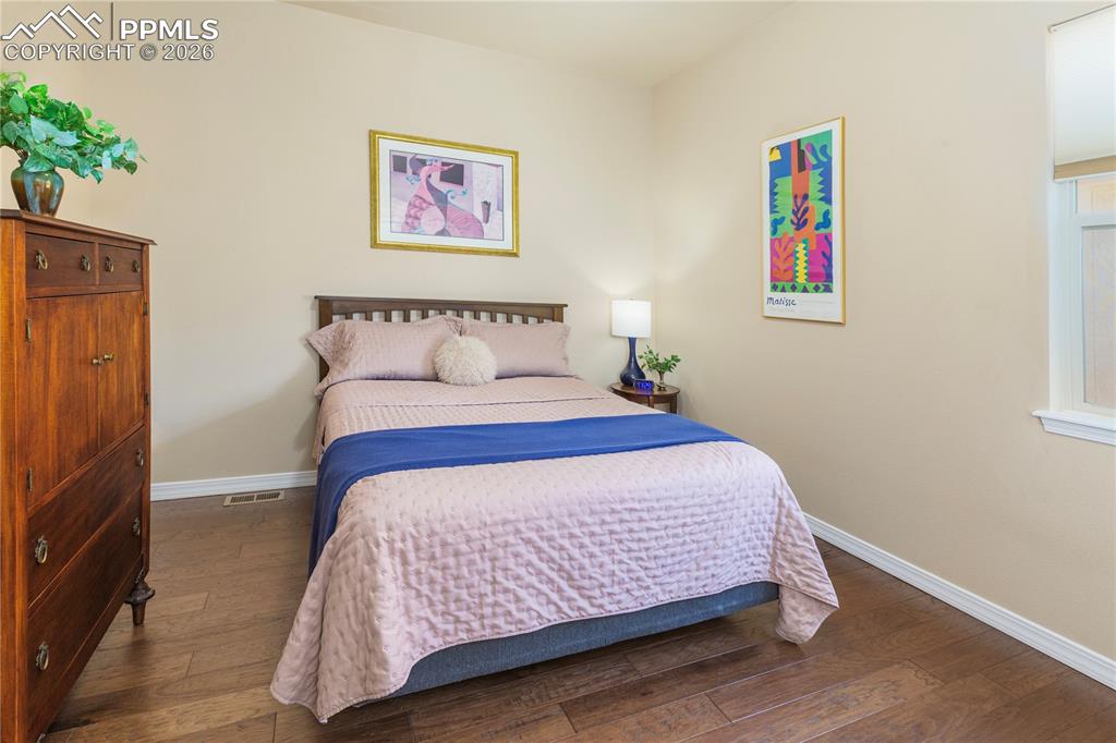 Image 31 of 50: Main-level guest bedroom is adjacent to the full-size bathroom and includes