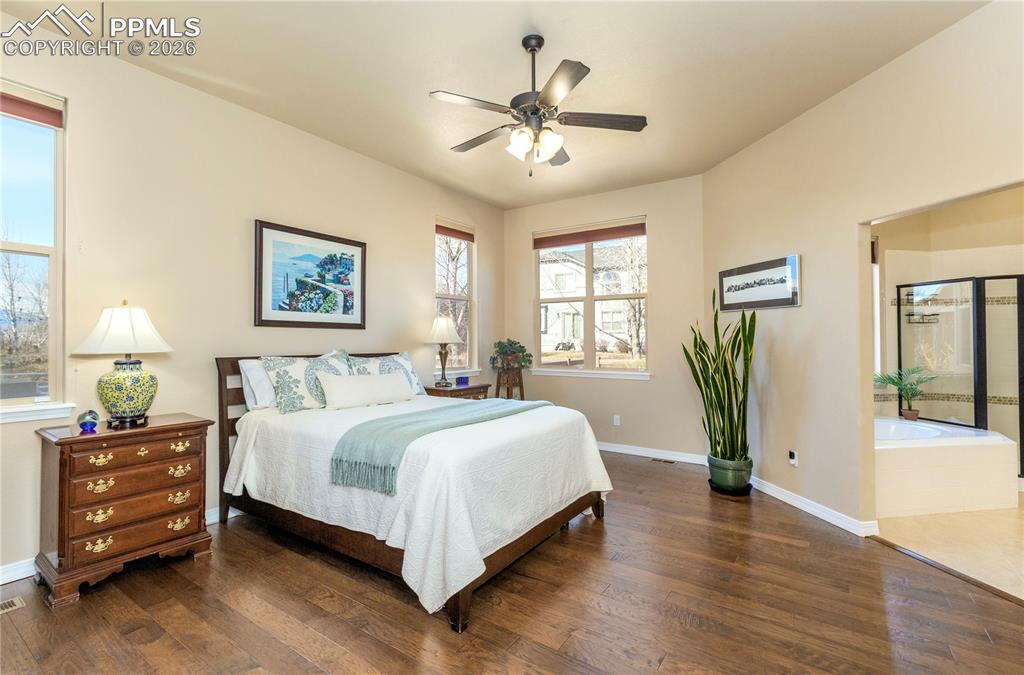 Image 32 of 50: Hickory wood floors continue into the private, spacious main-level primary 