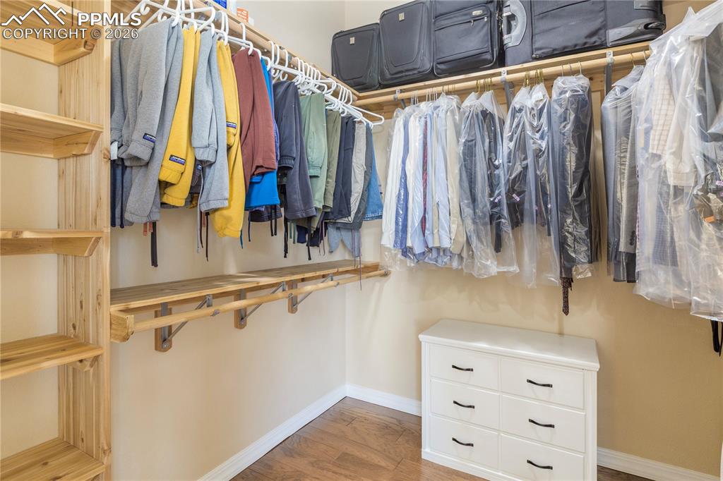 Image 37 of 50: Custom walk-in closet with cedar wood shelving and hickory wood floors. 