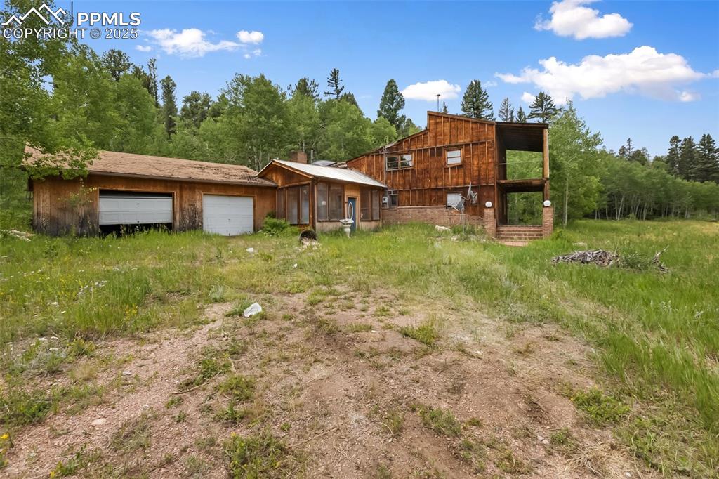 Image 28 of 36: Rear view of house with an attached garage