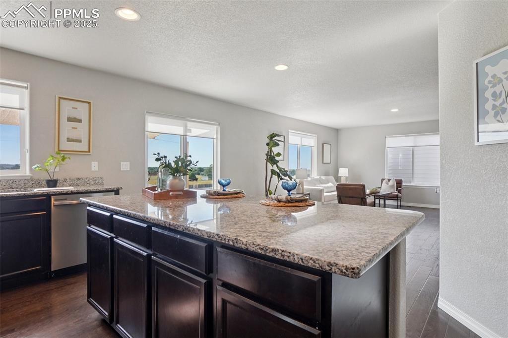 Image 13 of 46: Kitchen featuring recessed lighting, a textured ceiling, a kitchen island, 