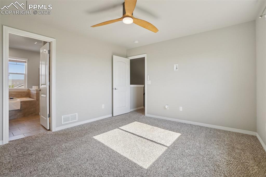 Image 14 of 46: Unfurnished bedroom featuring carpet flooring, ensuite bath, and a ceiling 