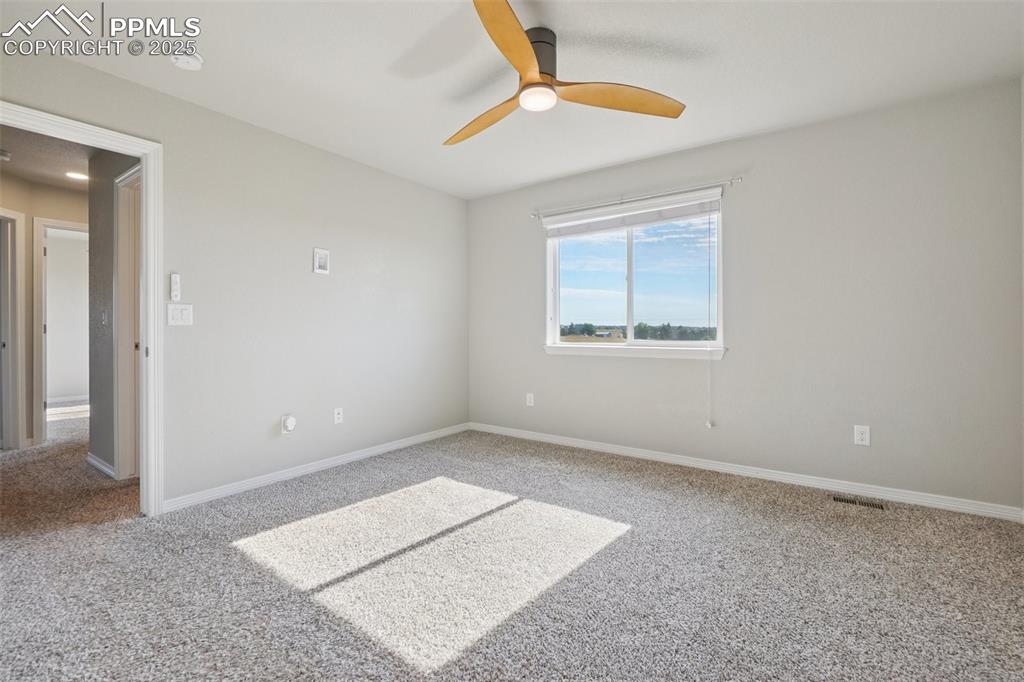 Image 18 of 46: Unfurnished room featuring carpet floors and a ceiling fan
