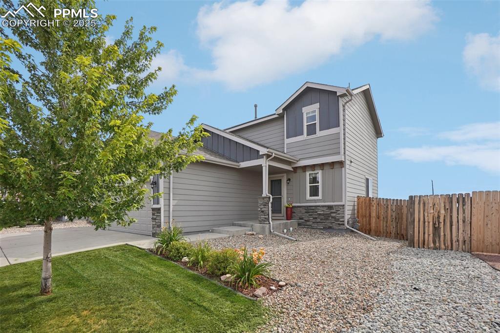 Image 2 of 46: View of front of property featuring stone siding, board and batten siding, 