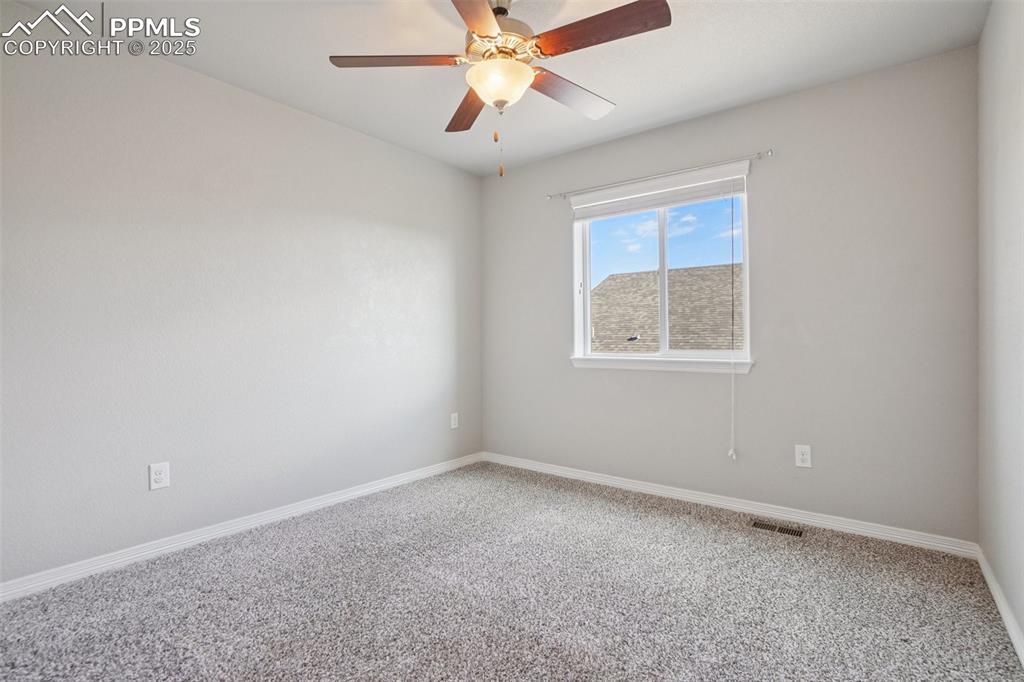Image 21 of 46: Carpeted spare room featuring baseboards and a ceiling fan