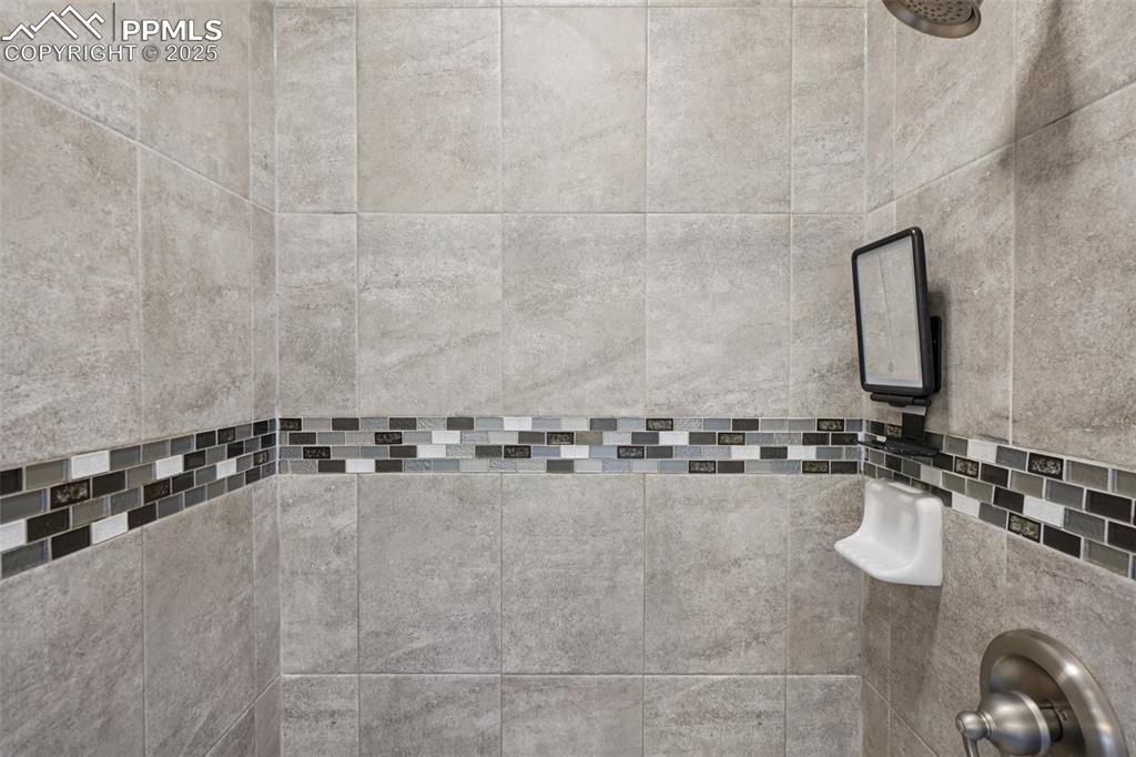 Image 28 of 46: Bathroom view of a tile shower