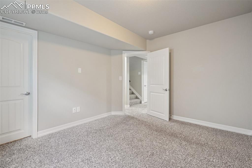 Image 31 of 46: Spare room featuring carpet flooring and stairs