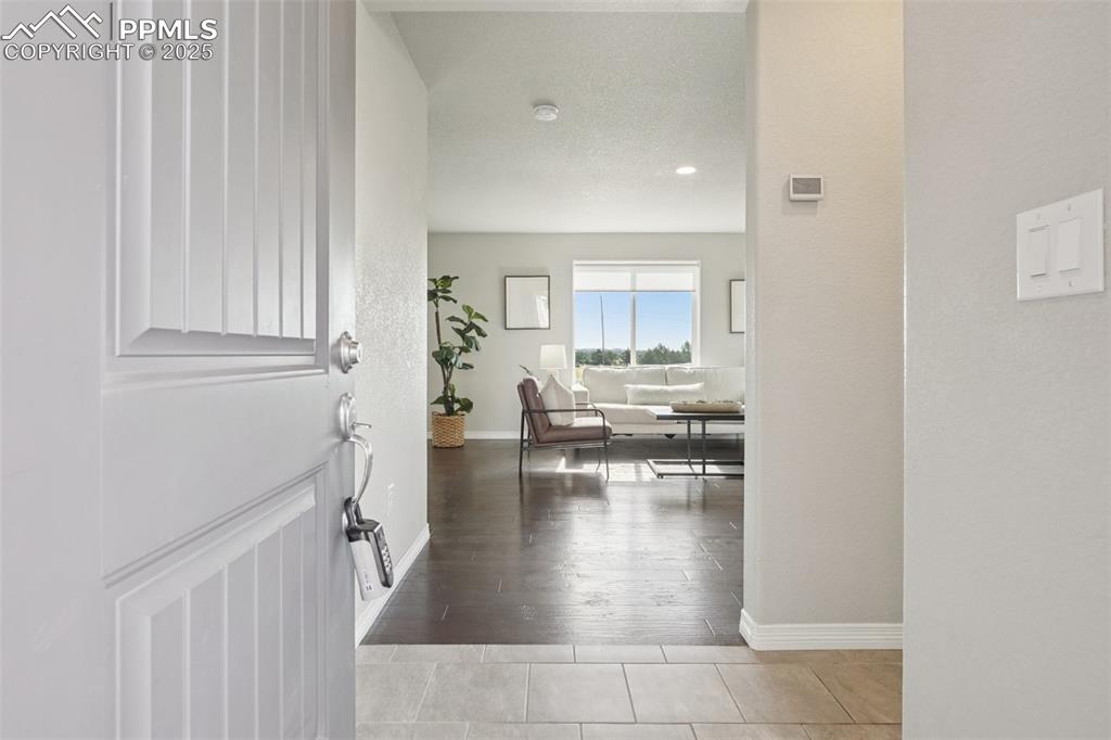 Image 32 of 46: Entryway with wood finished floors, recessed lighting, and a textured ceili