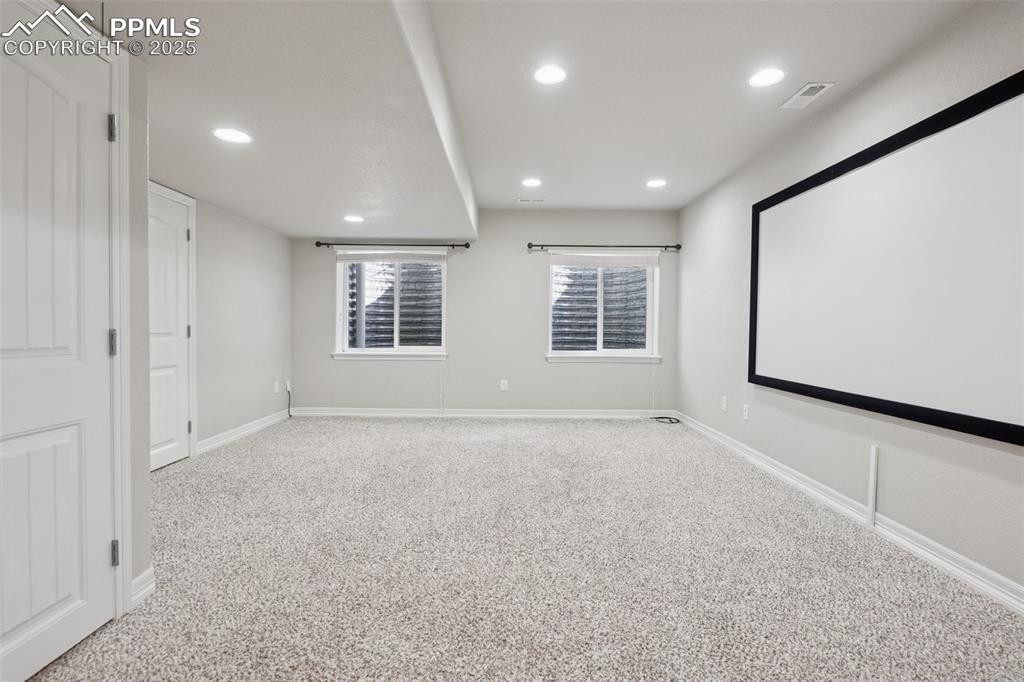 Image 36 of 46: Home theater featuring carpet floors and recessed lighting
