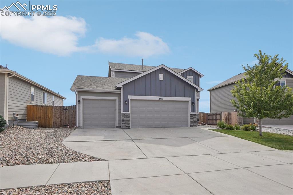 Image 46 of 46: View of front of house featuring board and batten siding, a shingled roof, 