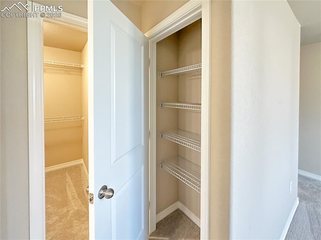 Image 21 of 36: Primary bedroom linen closet