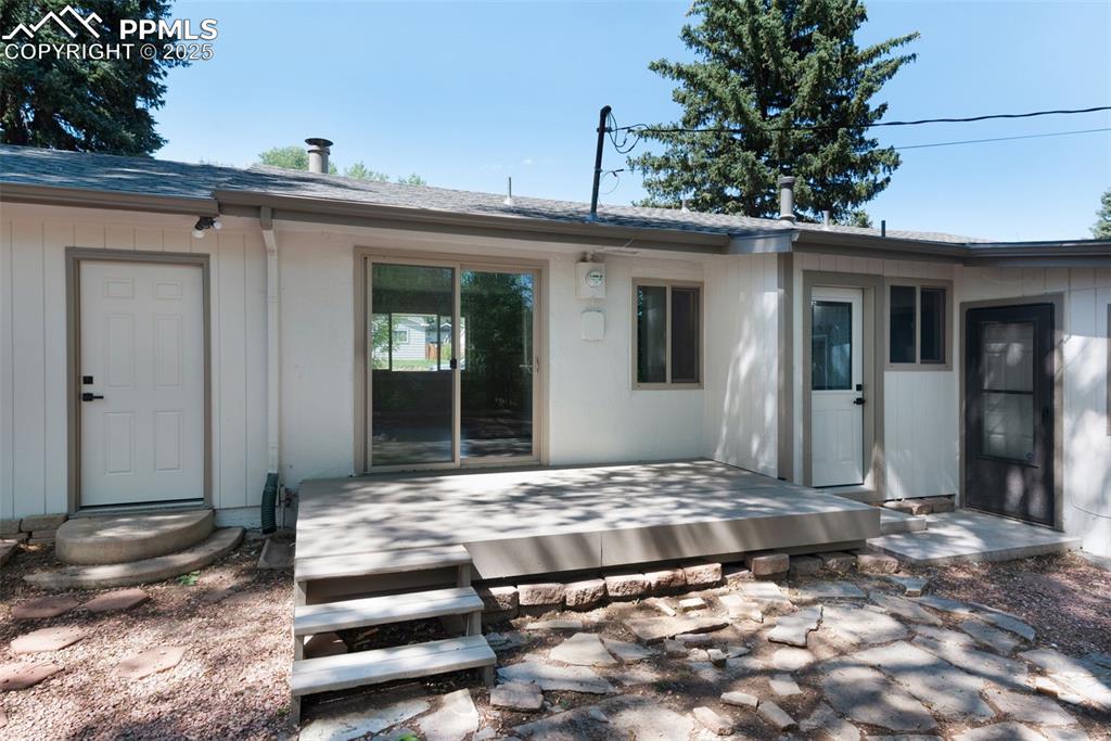 Image 30 of 33: Back of property featuring roof with shingles and a patio area