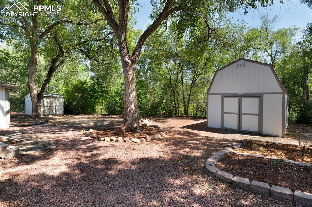 Image 31 of 33: View of yard featuring a storage shed