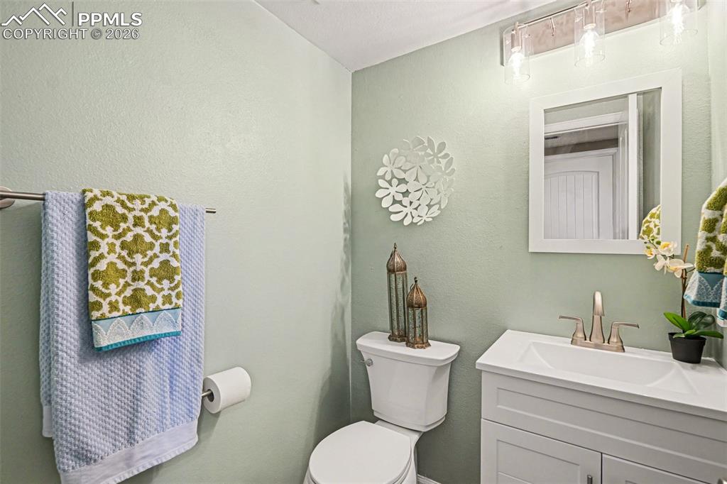 Image 10 of 24: The hall bathroom has been beautifully updated with a new vanity, toilet, L