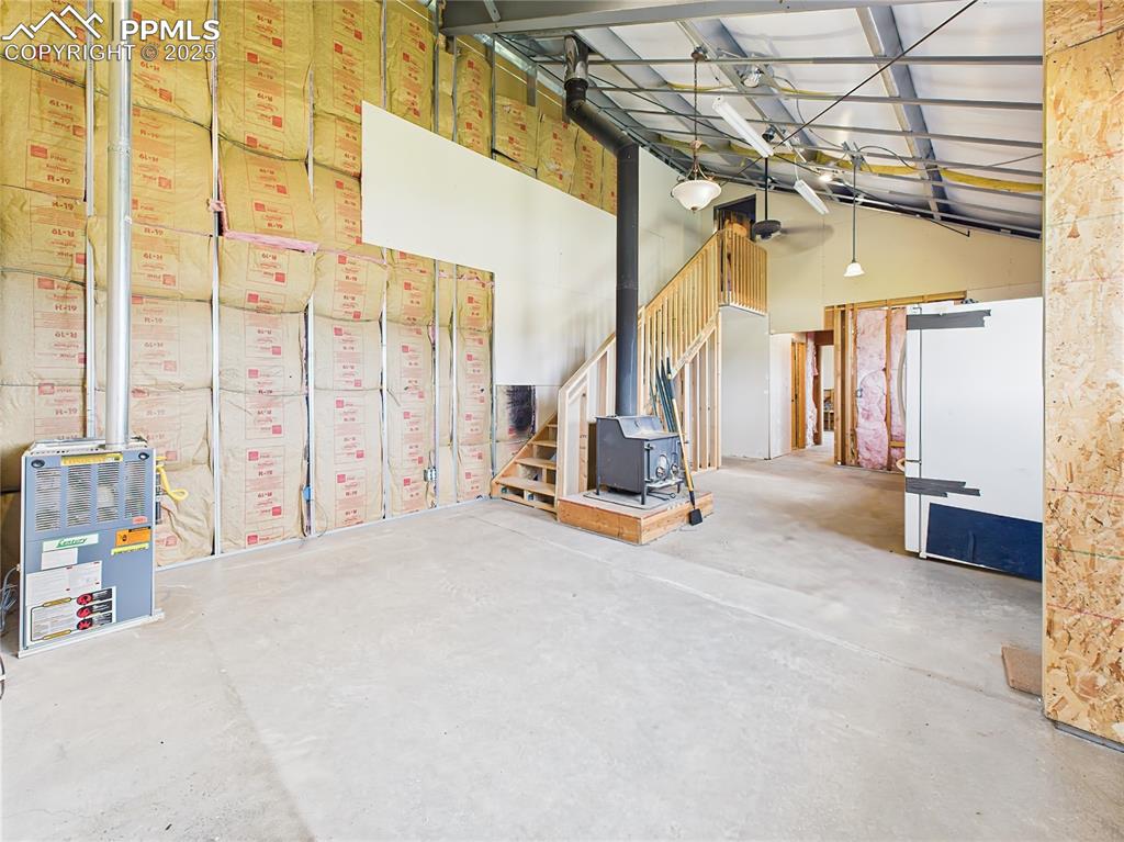 Image 16 of 50: Unfinished Room (Alternate View) – High ceilings and natural light from a l