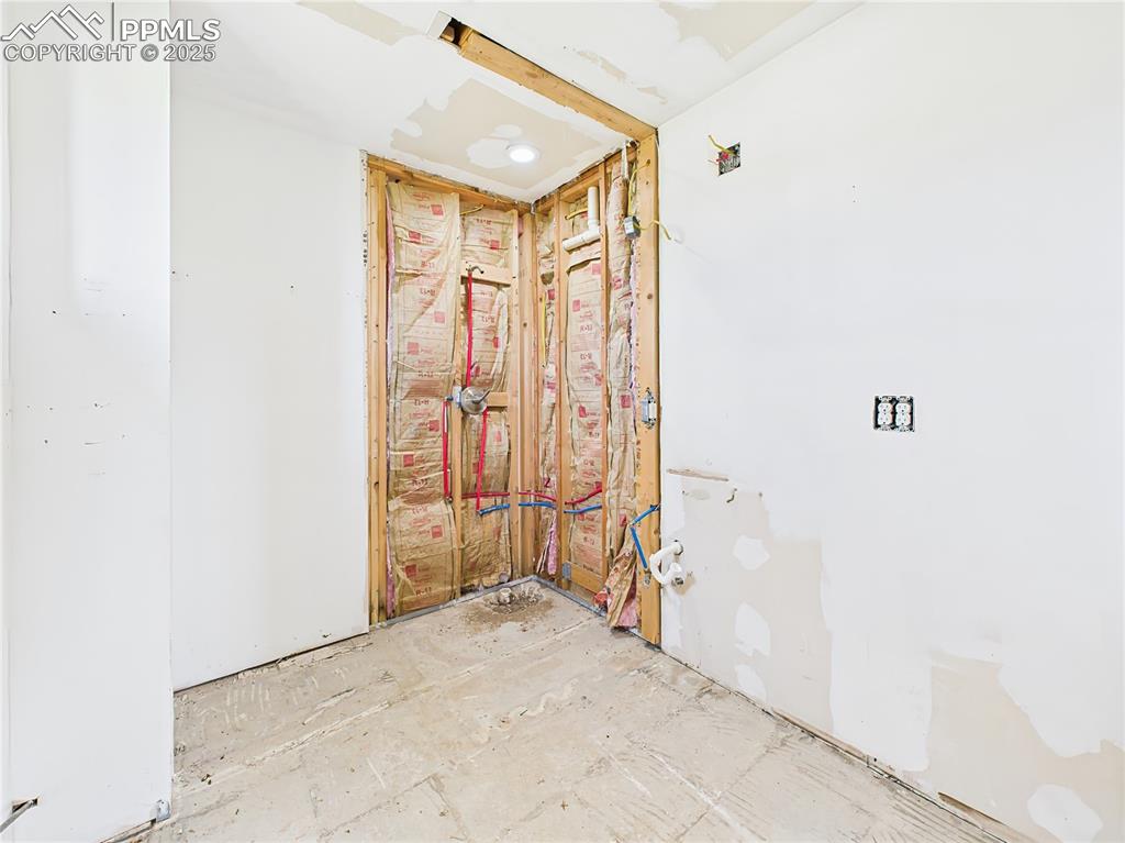 Image 24 of 50: Future Bathroom – Plumbing and insulation in place for a bathroom; recessed