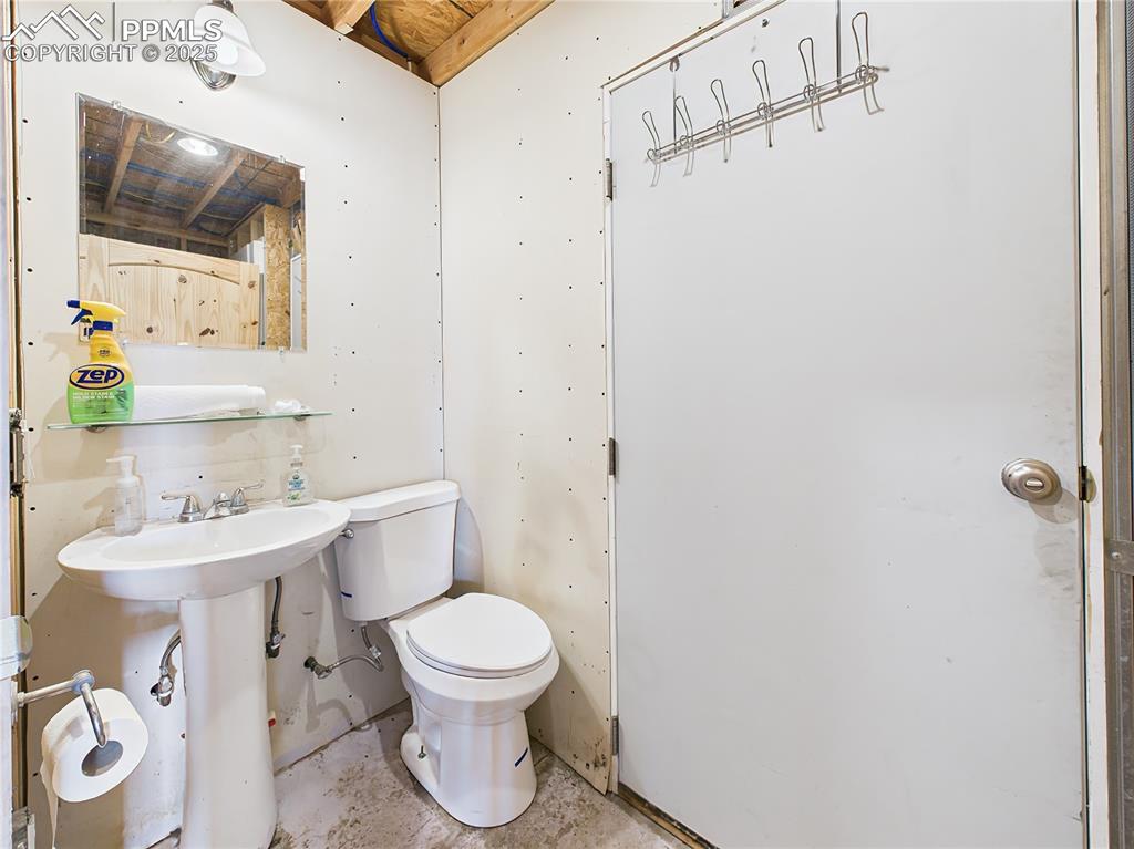 Image 25 of 50: Bathroom – Compact bathroom with pedestal sink and standard toilet, partial