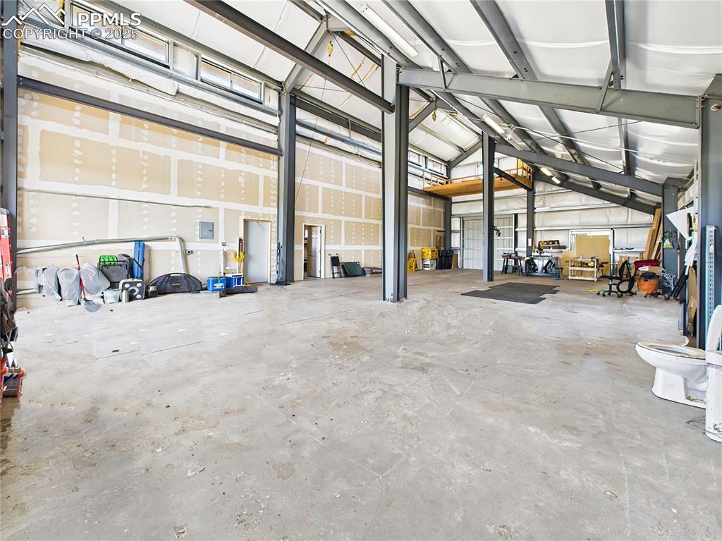 Image 9 of 50: Interior Overview – Looking Toward Rear – Expansive interior with soaring c