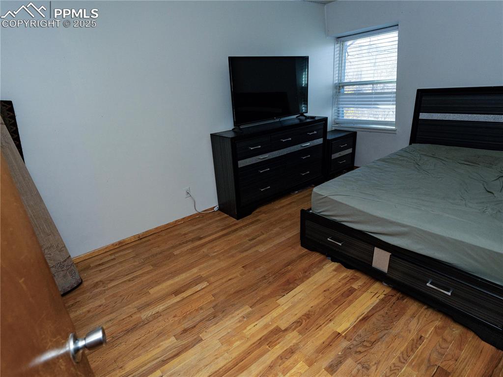 Image 19 of 23: Bedroom with light wood-type flooring