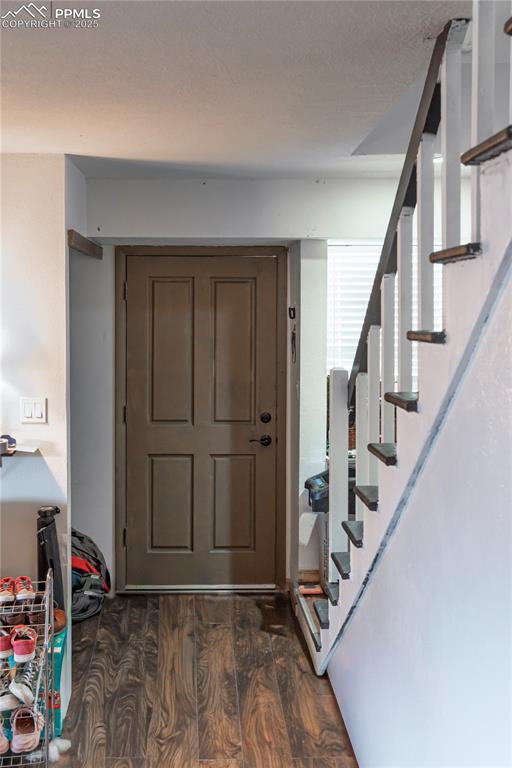 Image 3 of 23: Entryway with dark wood-style floors and stairs