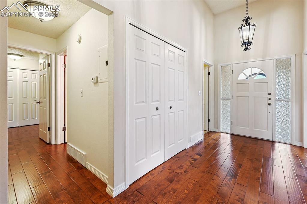 Image 4 of 32: Wide foyer for welcoming guests, complete with a large coat closet.