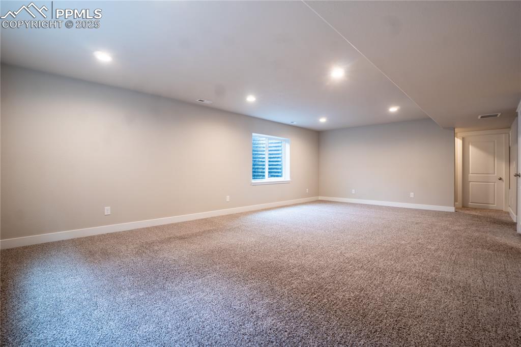 Image 28 of 35: Spare room with light colored carpet and recessed lighting