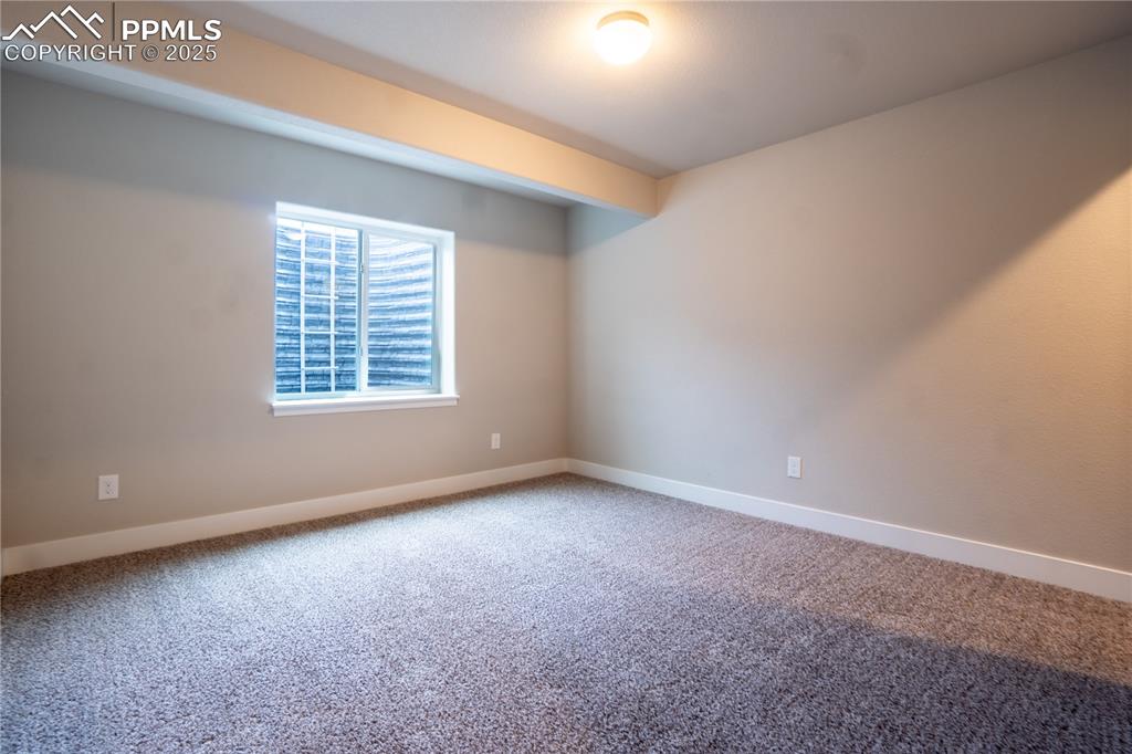Image 30 of 35: Empty room featuring carpet and baseboards