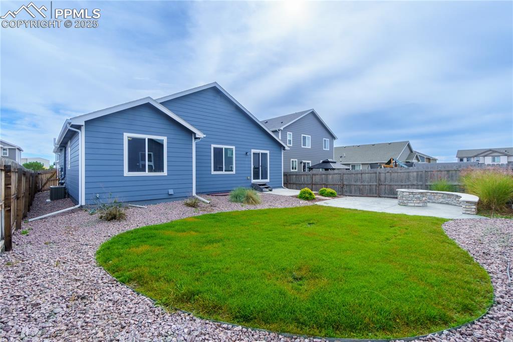 Image 34 of 35: Rear view of house with a patio area and a fenced backyard