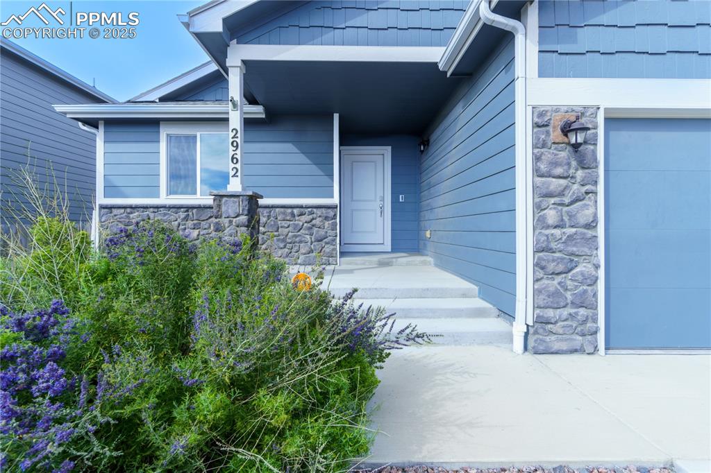 Image 4 of 35: Property entrance featuring stone siding