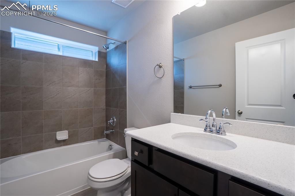 Image 7 of 35: Full bath featuring bathing tub / shower combination, vanity, and a texture