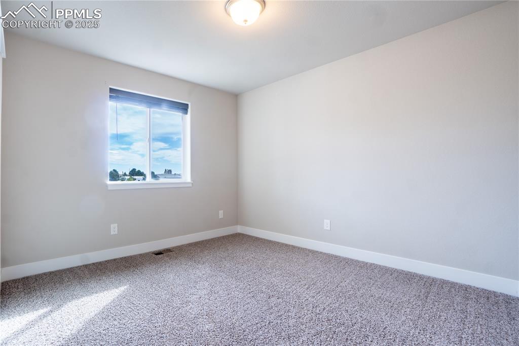 Image 8 of 35: Spare room featuring baseboards and carpet flooring