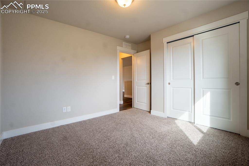 Image 9 of 35: Unfurnished bedroom featuring carpet flooring and a closet
