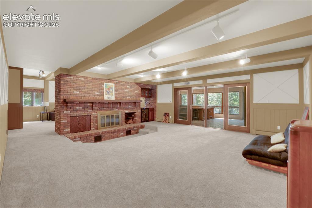 Image 22 of 46: Another inviting space in the basement with a sunken conversation area.
