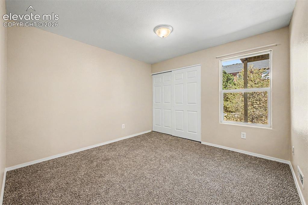 Image 18 of 32: Main level second bedroom