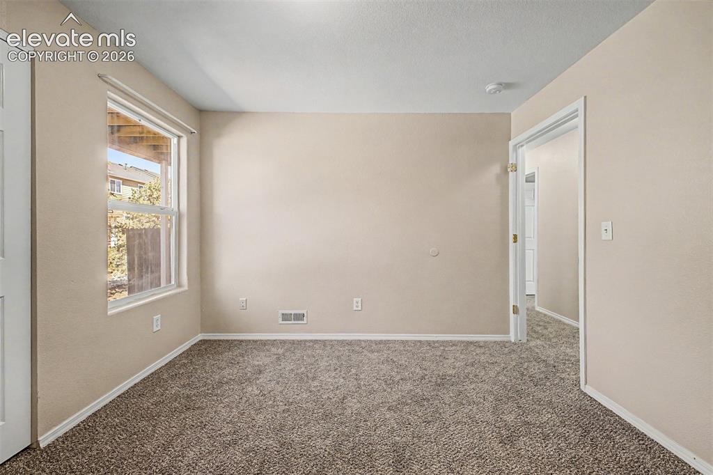 Image 19 of 32: Main level second bedroom