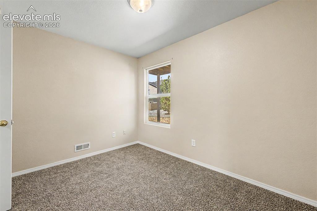 Image 20 of 32: Main level third bedroom