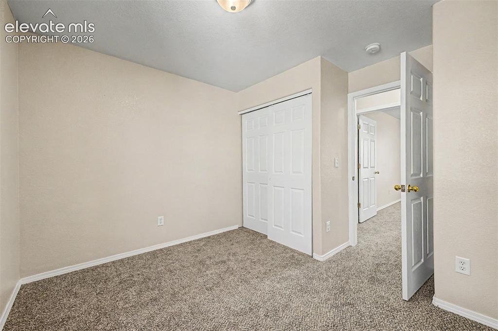 Image 21 of 32: Main level third bedroom