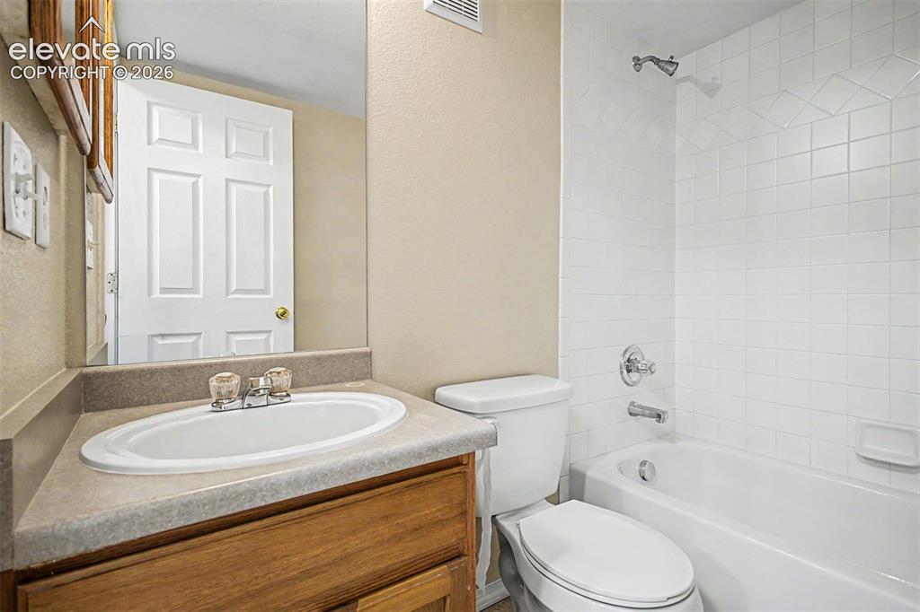 Image 22 of 32: Main level full secondary bathroom