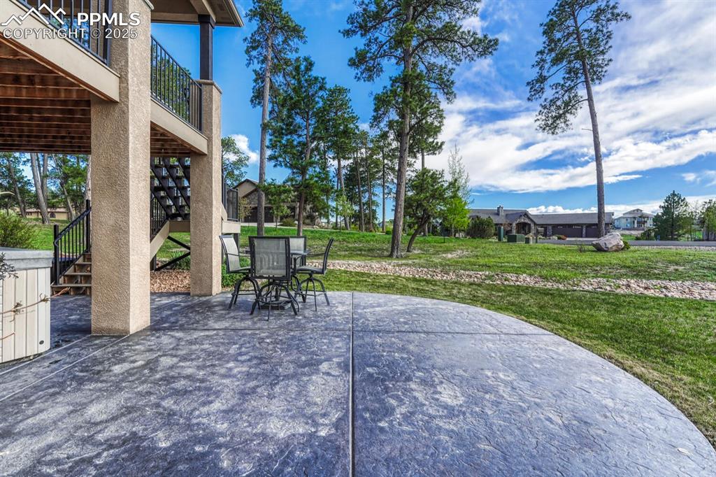 Image 42 of 50: View of patio with stairs and outdoor dining area