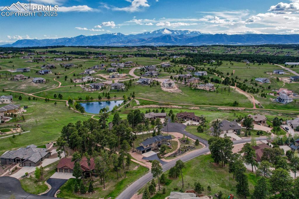 Image 49 of 50: Aerial view of residential area featuring a water and mountain view