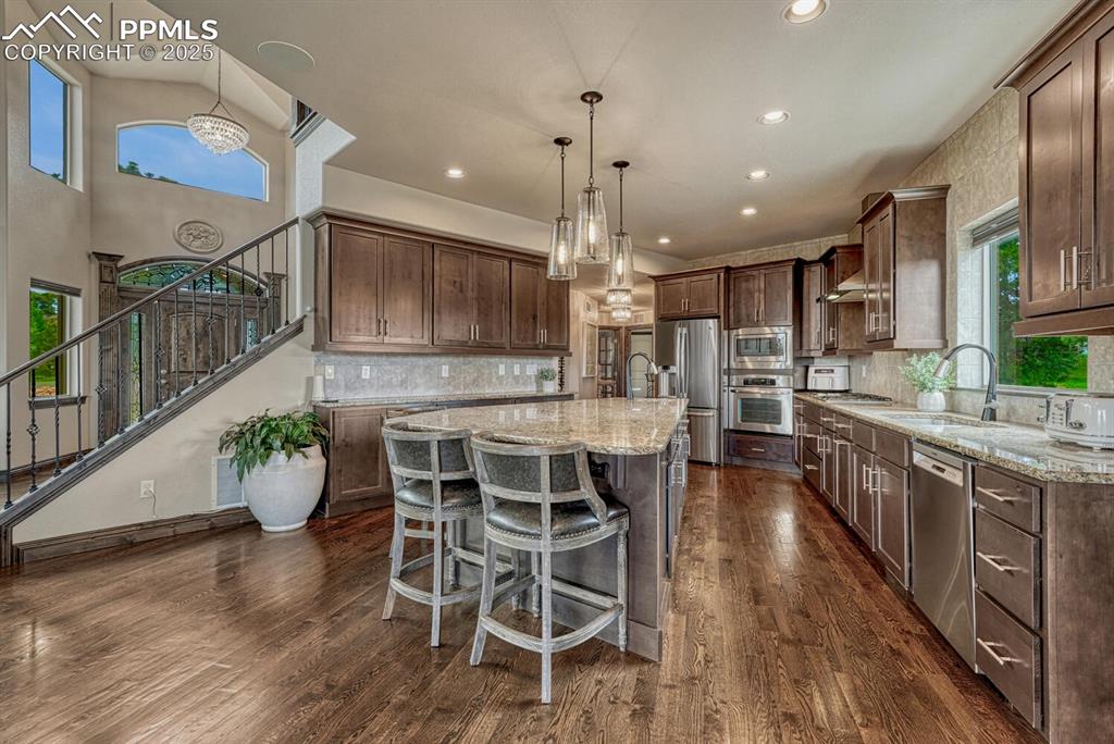 Image 9 of 50: Kitchen featuring appliances with stainless steel finishes, a sink, a kitch