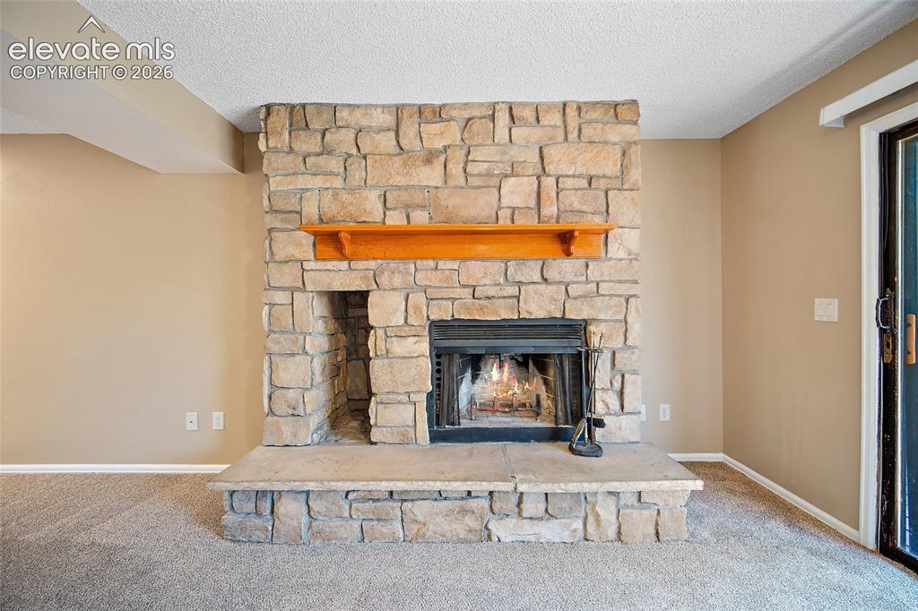 Image 5 of 42: Beautiful wood burning stone fireplace